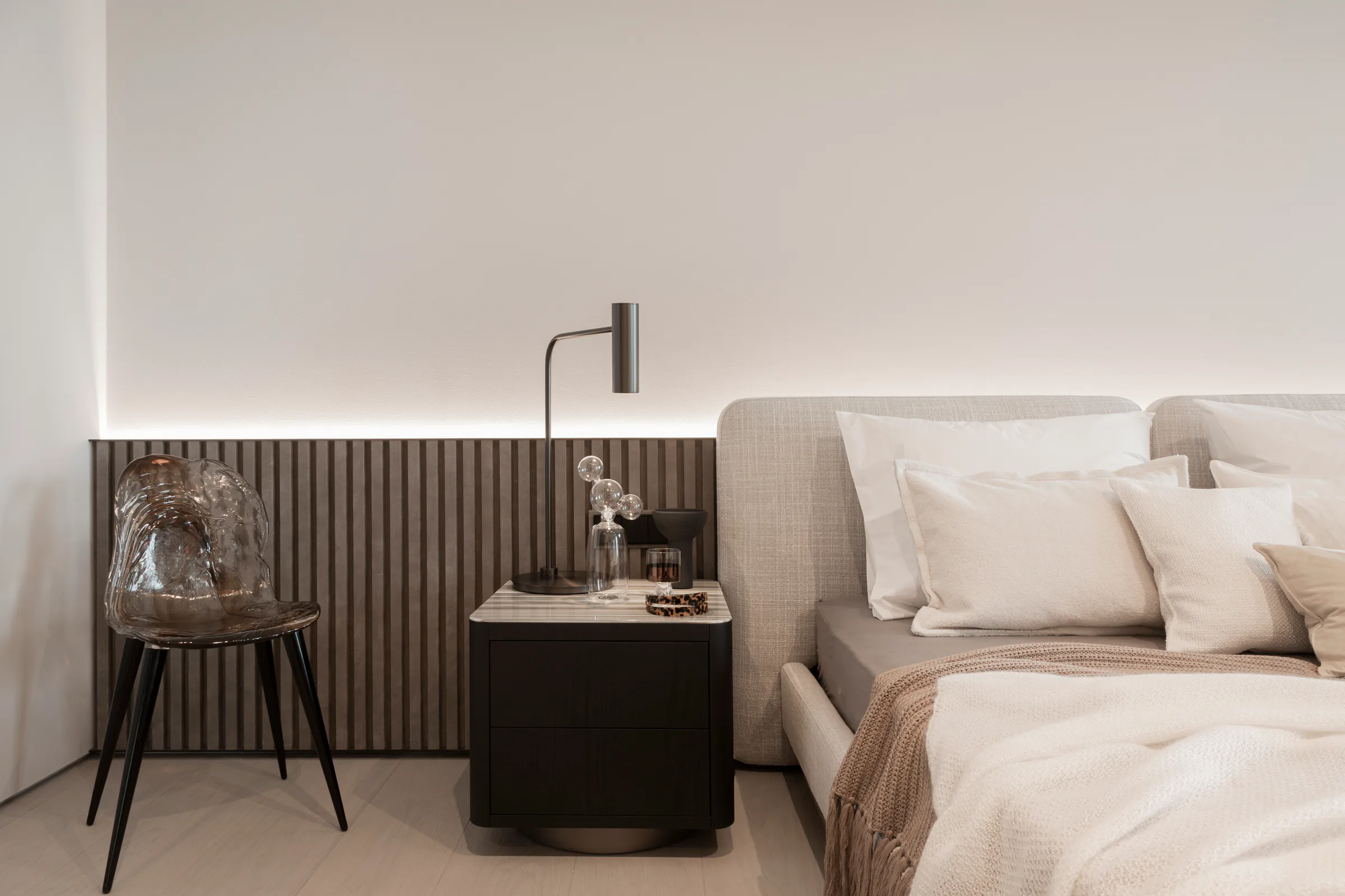 Skyline Serenity bedroom with an upholstered bed, lamp and dark wall panelling